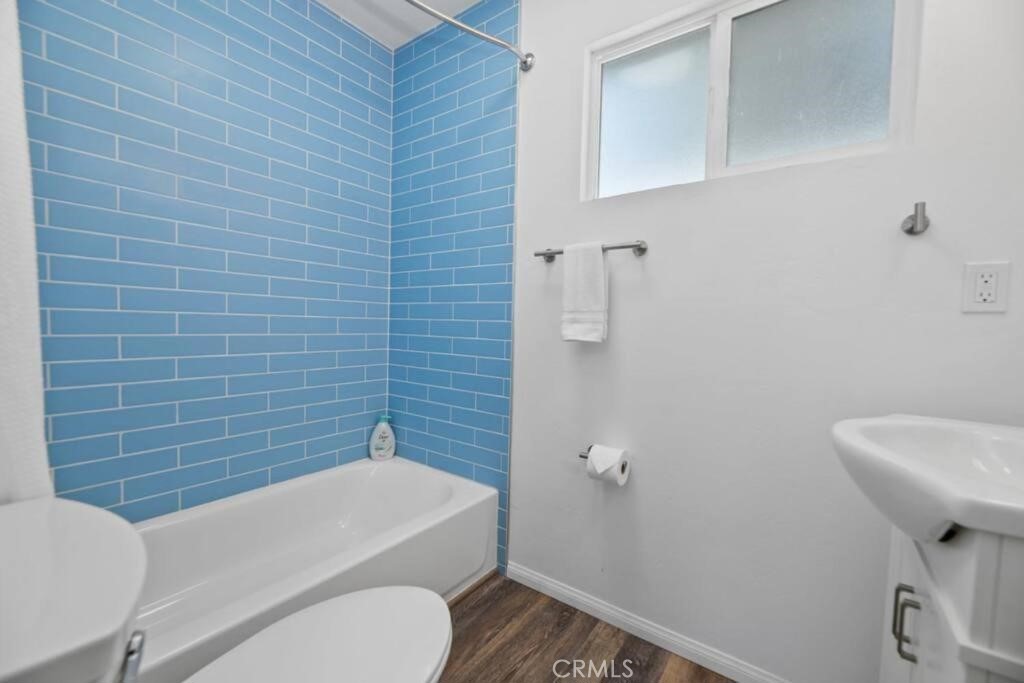 560 Edgemoor Road, Unit 5 Big Bear Lake, CA 92315 - Photo 9 of 10 a bathroom with a toilet a sink and mirror