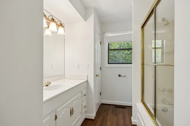 a bathroom with a sink a mirror and a shower