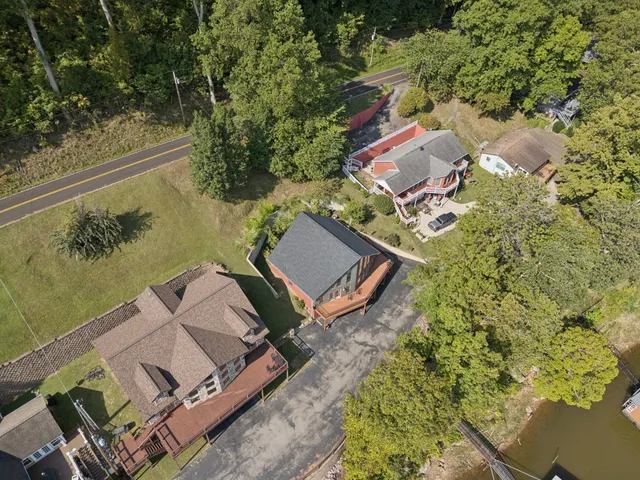 an aerial view of a houses with ocean view