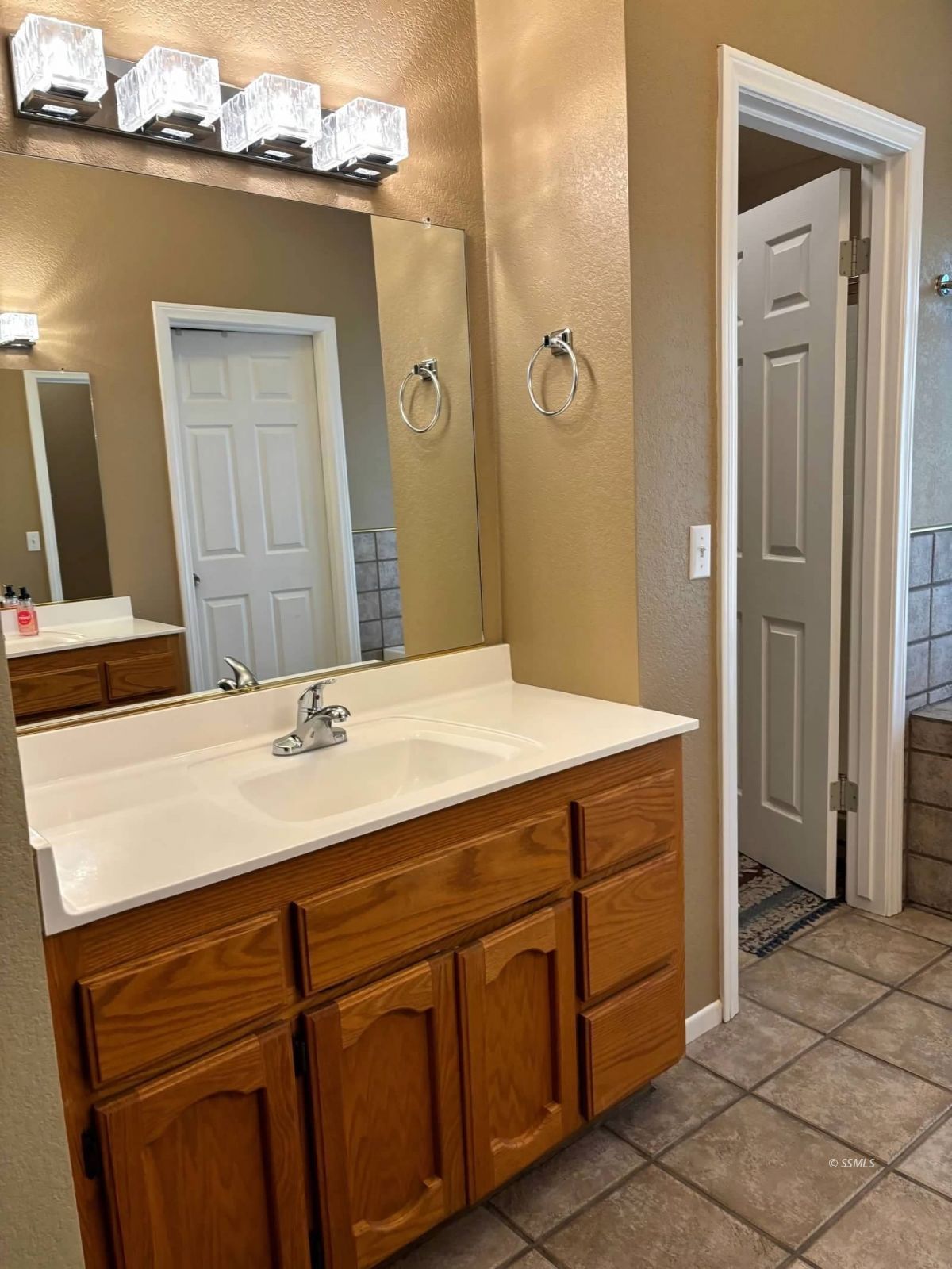424 Olive Avenue Ridgecrest, CA 93555 - Photo 32 of 46 a bathroom with a sink vanity and a mirror