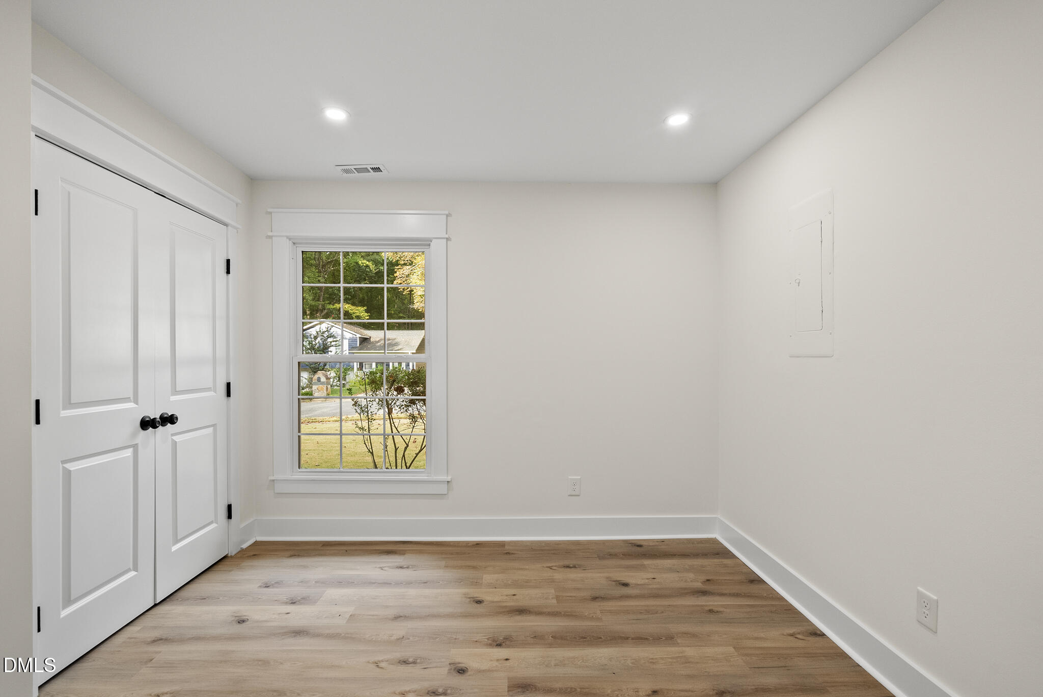 7804 Brandyapple Drive Raleigh, NC 27615 - Photo 31 of 58 a view of an empty room with wooden floor and a window