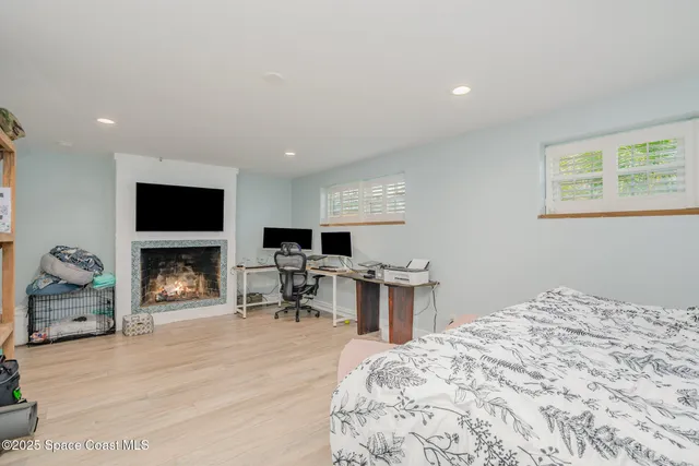 a bedroom with furniture and a fireplace