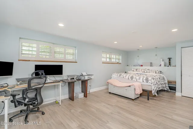 a spacious bedroom with a bed a desk and chair