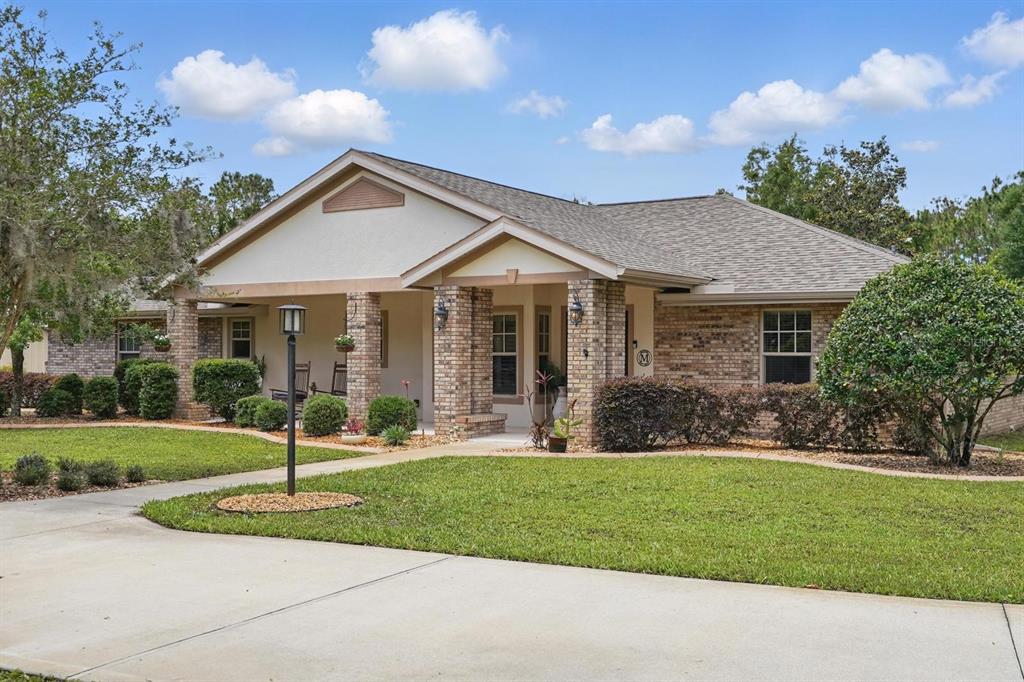 a front view of a house with a yard and trees
