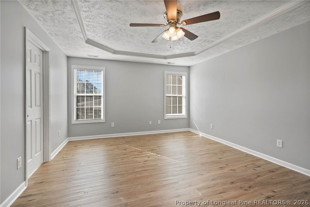5353 Pringle Way Hope Mills, NC 28348 - Photo 12 of 29 wooden floor in an empty room with a window