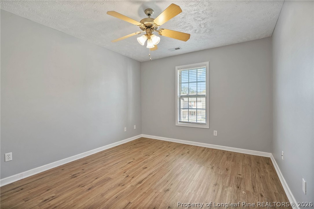 5353 Pringle Way Hope Mills, NC 28348 - Photo 21 of 29 wooden floor in an empty room with a window