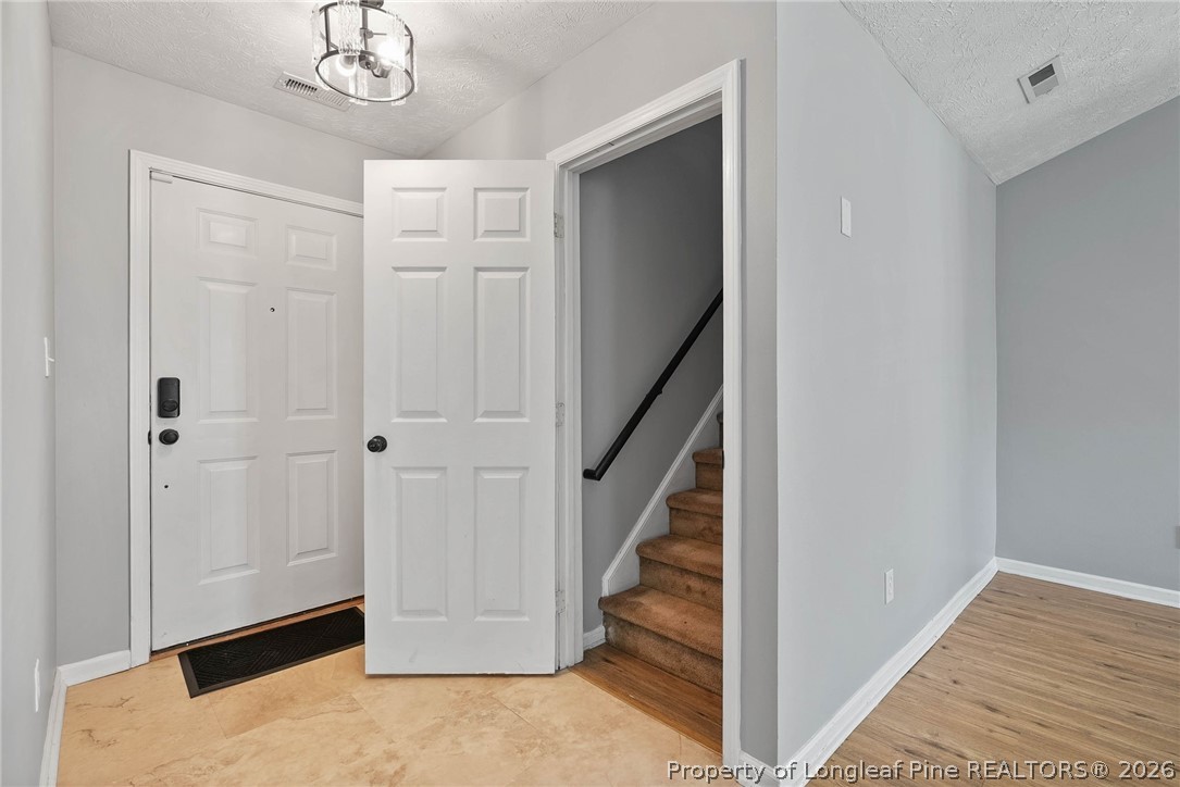 5353 Pringle Way Hope Mills, NC 28348 - Photo 23 of 29 a view of a hallway with wooden floor and staircase