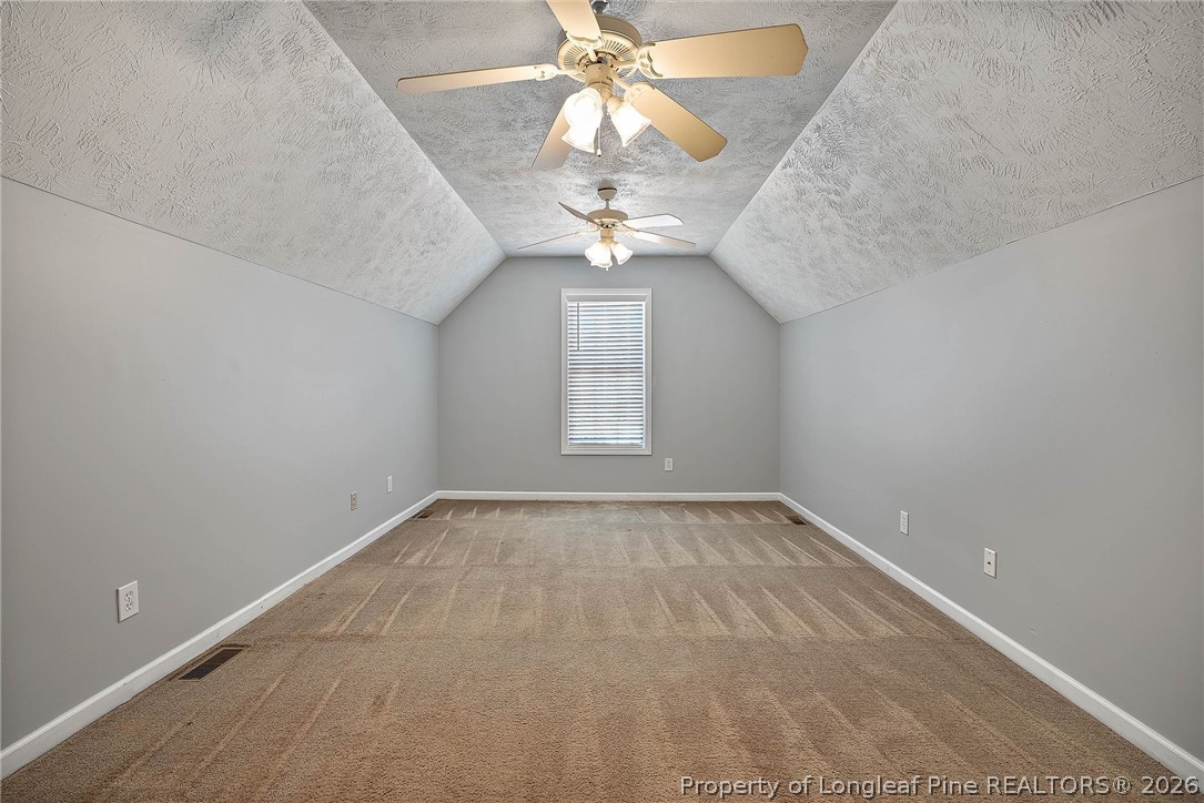 5353 Pringle Way Hope Mills, NC 28348 - Photo 25 of 29 en empty room with windows and chandelier fan