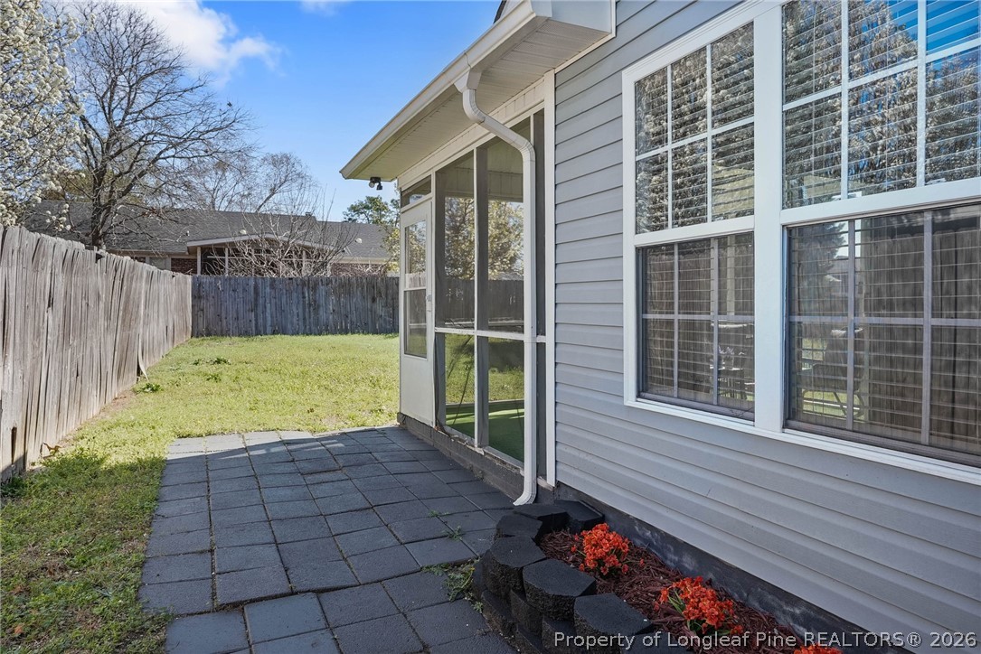 5353 Pringle Way Hope Mills, NC 28348 - Photo 27 of 29 a view of a backyard with table and chairs and wooden fence