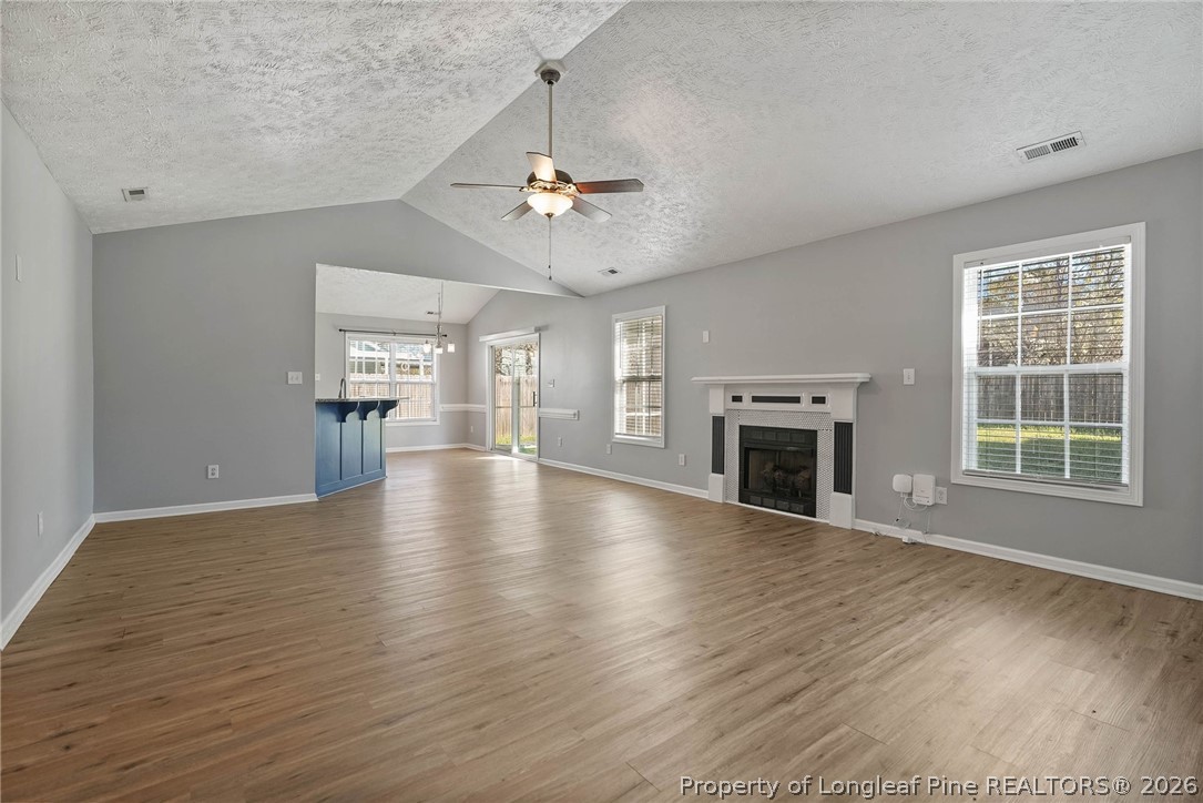 5353 Pringle Way Hope Mills, NC 28348 - Photo 3 of 29 an empty room with windows chandelier and fireplace