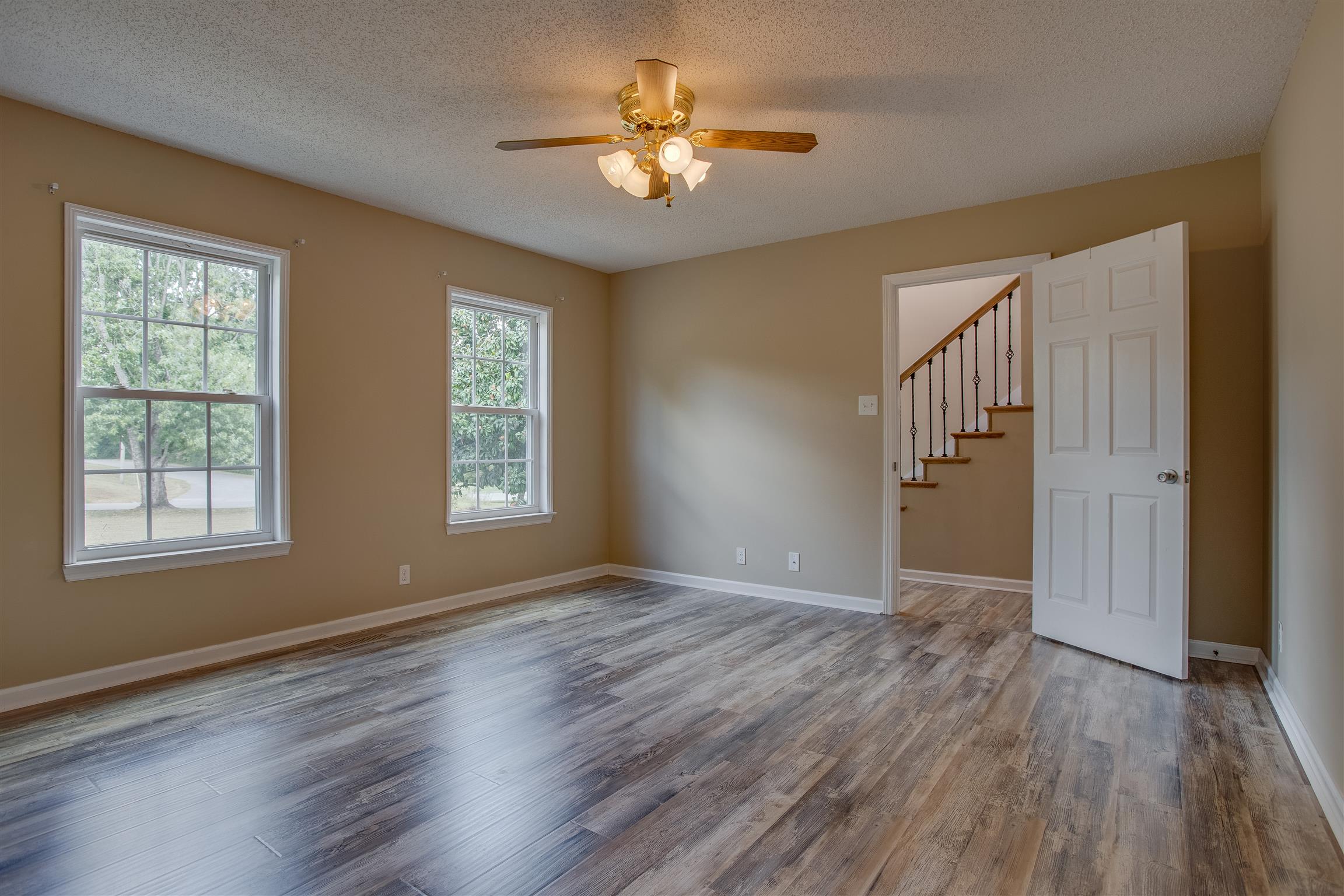 878 Tom Osborne Road Columbia, TN 38401 - Photo 13 of 26 Bright and airy Master is located on main floor. Features ceiling fan, those beautiful floors, and an awesome closet/dressing area!!