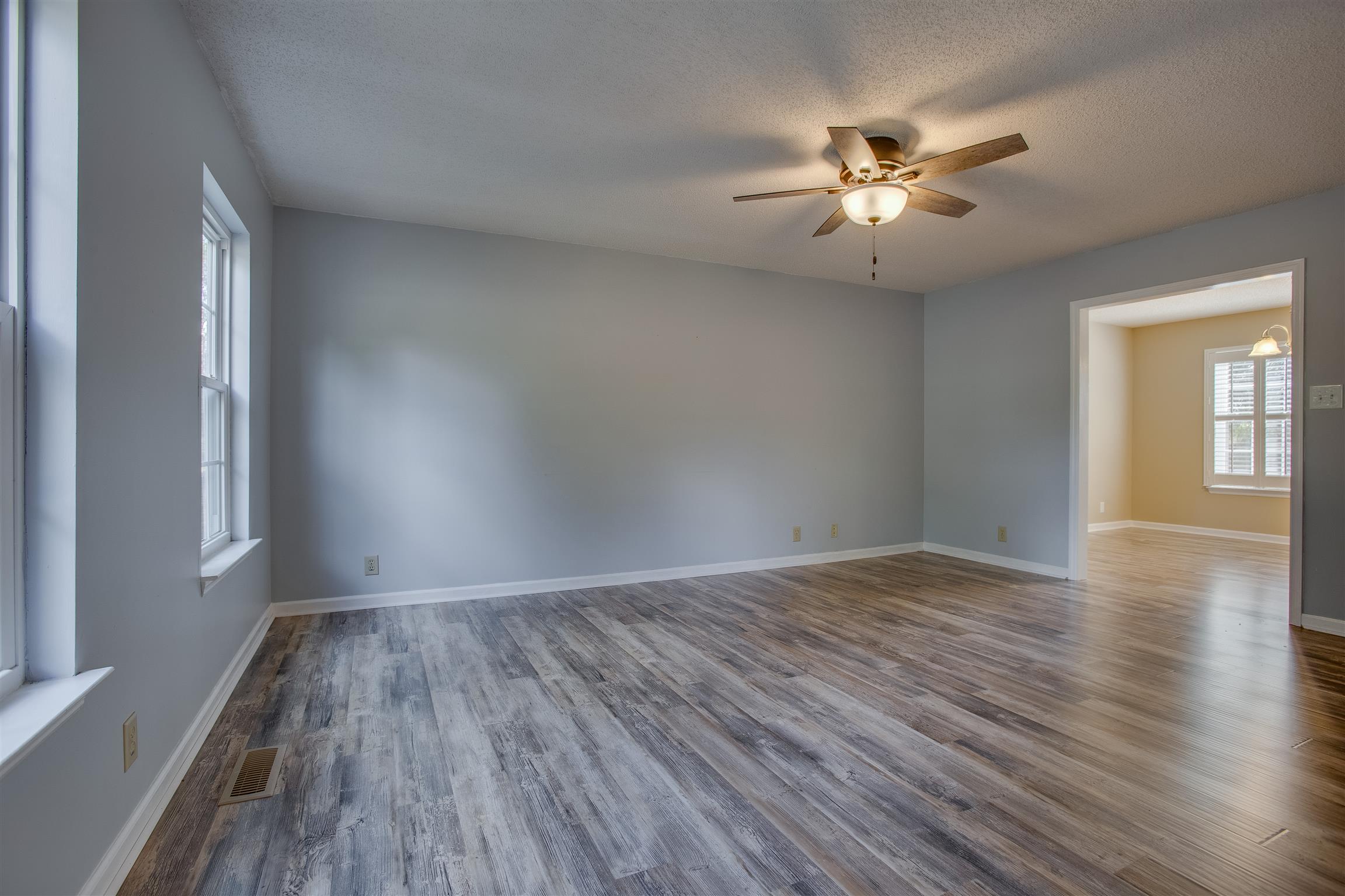 Formal living room with neutral paint and gorgeous new floors