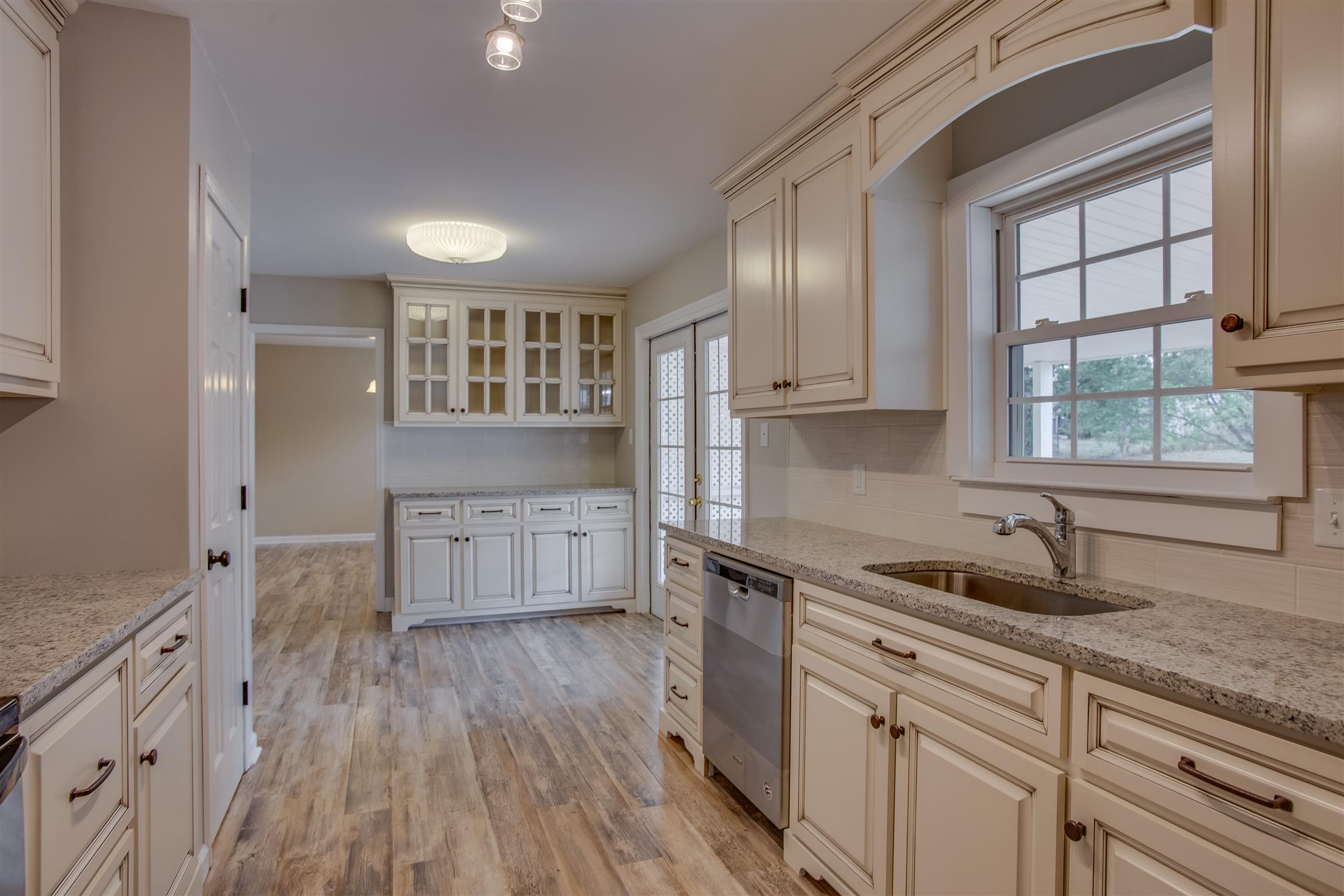 Stunning NEW chef's kitchen! Custom cabinets and granite counters, pantry, and additional cabinets with glass uppers for displaying the fine china!