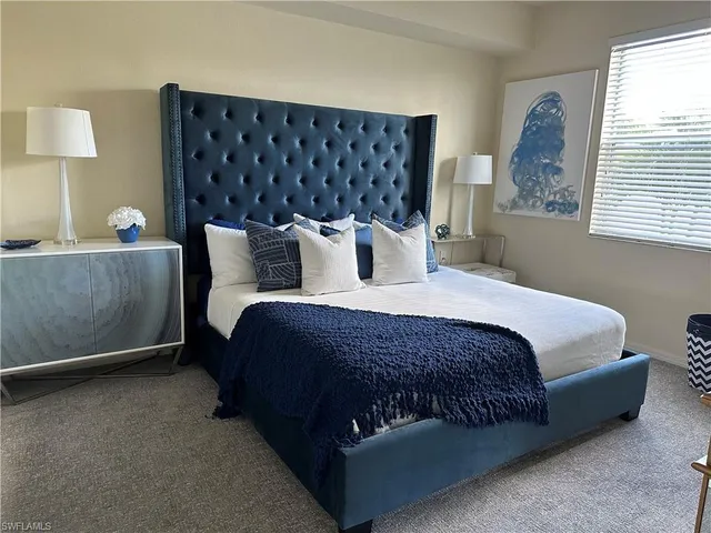 a bedroom with furniture and a flat screen tv