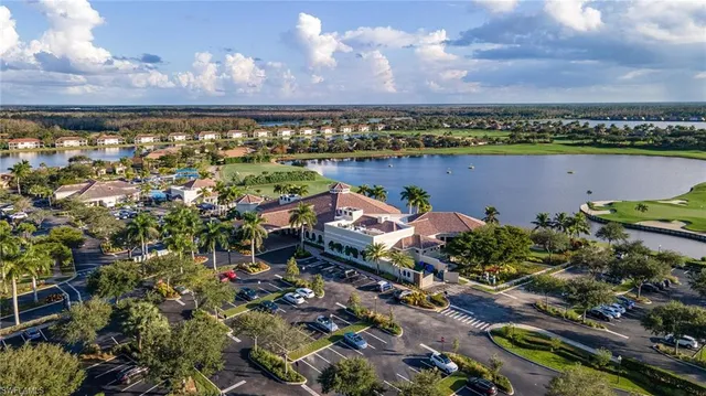 an aerial view of residential houses with outdoor space and river