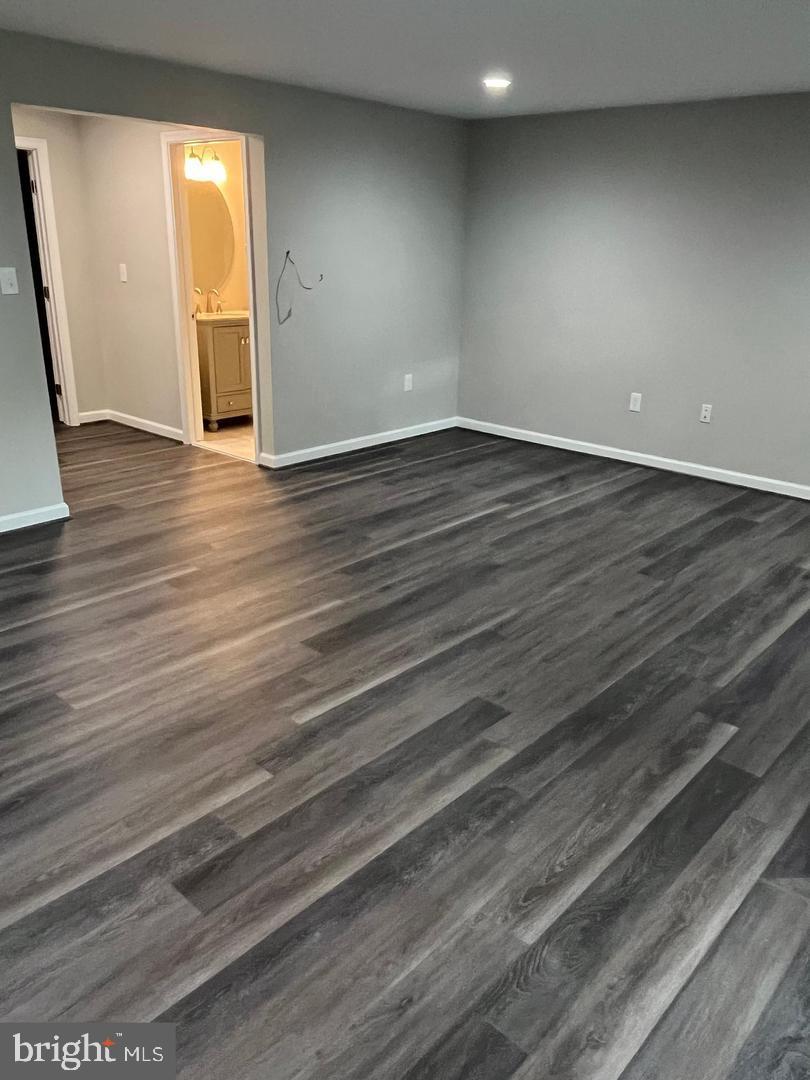 355 Crescendo Way Silver Spring, MD 20901 - Photo 14 of 23 a view of an empty room with wooden floor and a window