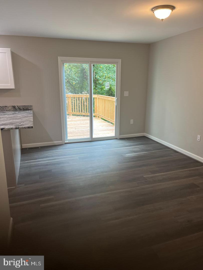 355 Crescendo Way Silver Spring, MD 20901 - Photo 18 of 23 a view of an empty room with wooden floor and a window