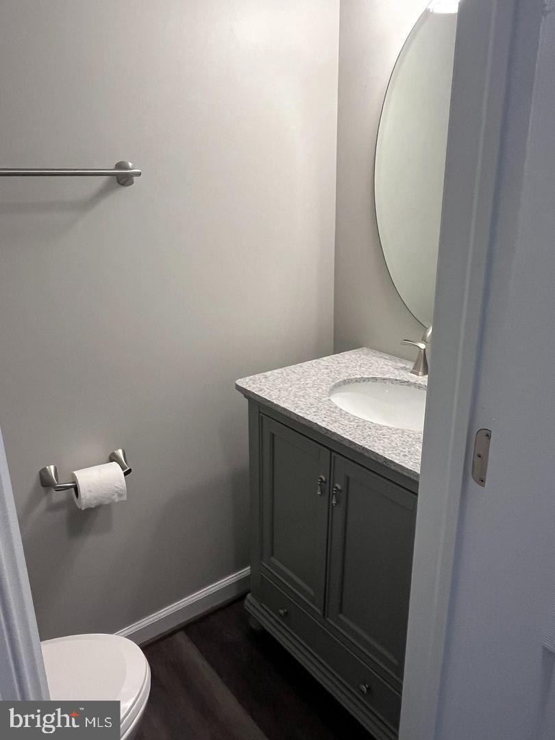 355 Crescendo Way Silver Spring, MD 20901 - Photo 22 of 23 a bathroom with a granite countertop toilet and a sink