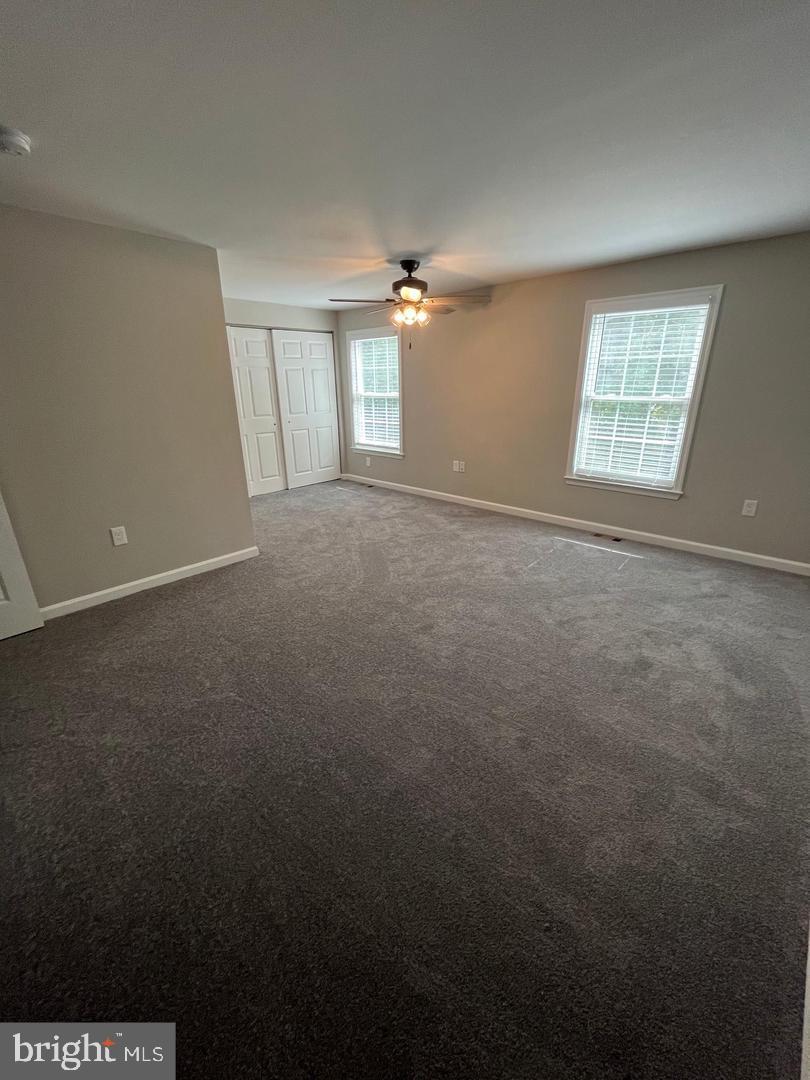 355 Crescendo Way Silver Spring, MD 20901 - Photo 10 of 23 an empty room with windows and fan