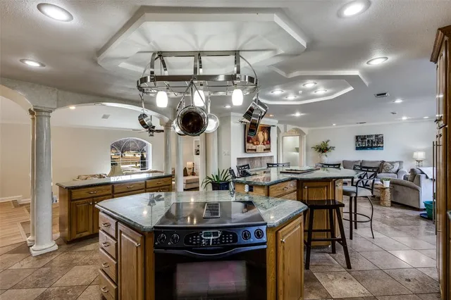 a kitchen with a stove a table and chairs in it