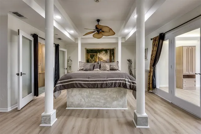 a bedroom with a large bed and a chandelier