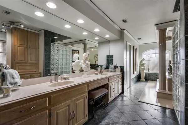 a spacious bathroom with a double vanity sink a and a large mirror