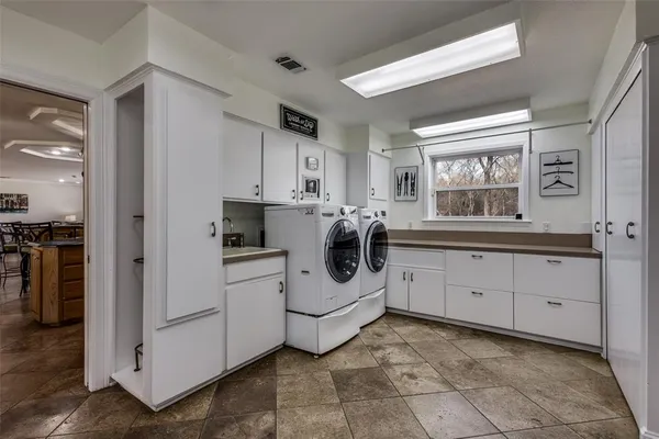 a kitchen with white cabinets and white appliances