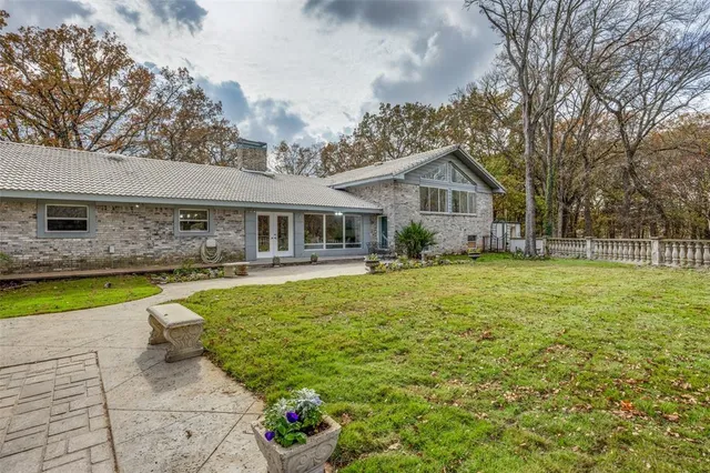 a front view of house with yard and swimming pool