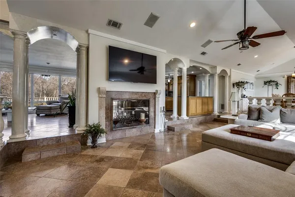 a living room with furniture a flat screen tv and a fireplace