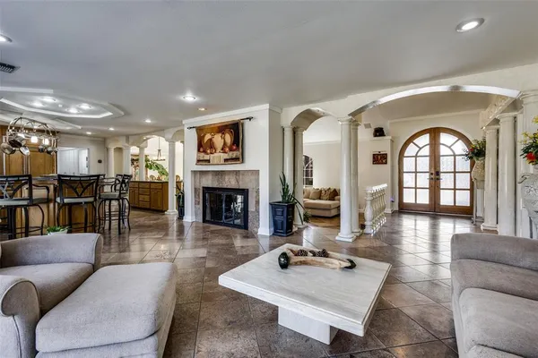 a living room with furniture fireplace and a table