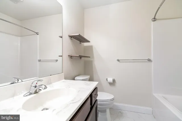 a view of a small space with wooden floor and a window