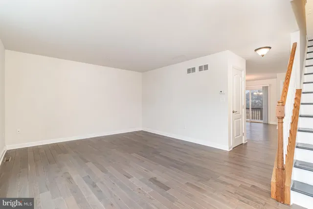 a view of a room with wooden floor