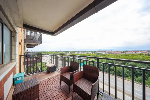 a balcony with wooden floor outdoor seating and city view