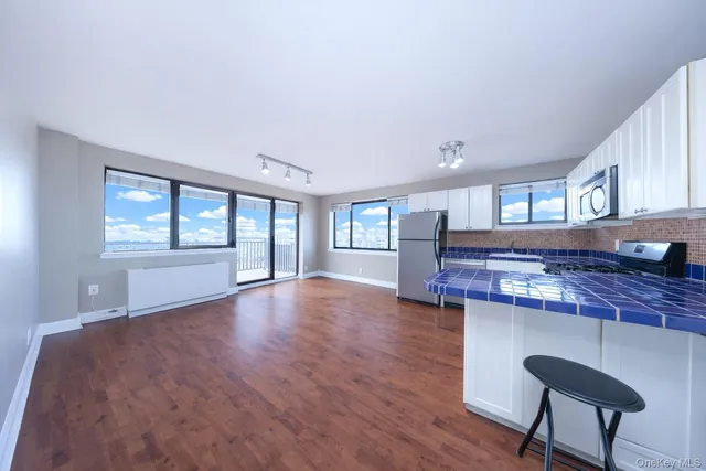 a view of a kitchen with a sink and a large window