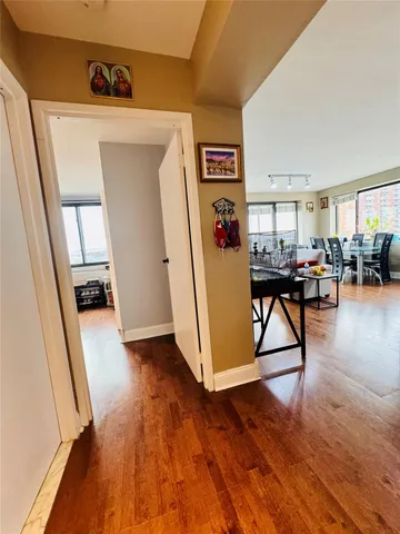 a view of a hallway with wooden floor and furniture