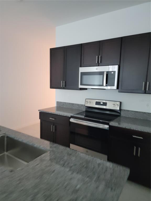 1844 Red Loop Lakeland, FL 33801 - Photo 8 of 24 a kitchen with a stove and a microwave