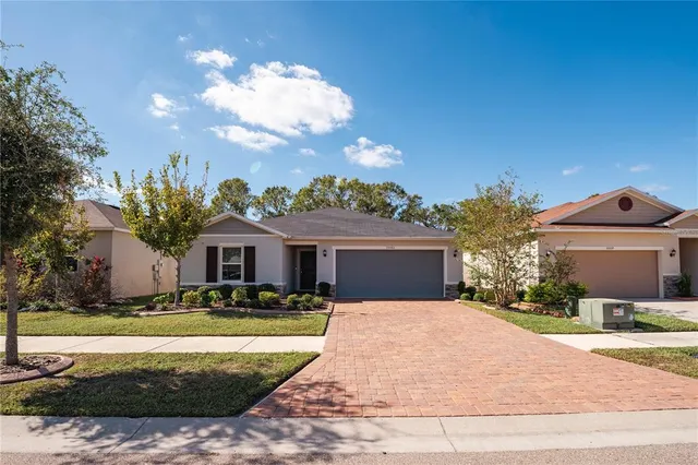 a front view of house with yard and trees around