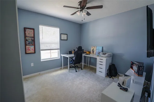 a livingroom with workspace and a window