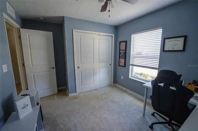 a view of a hallway to rooms