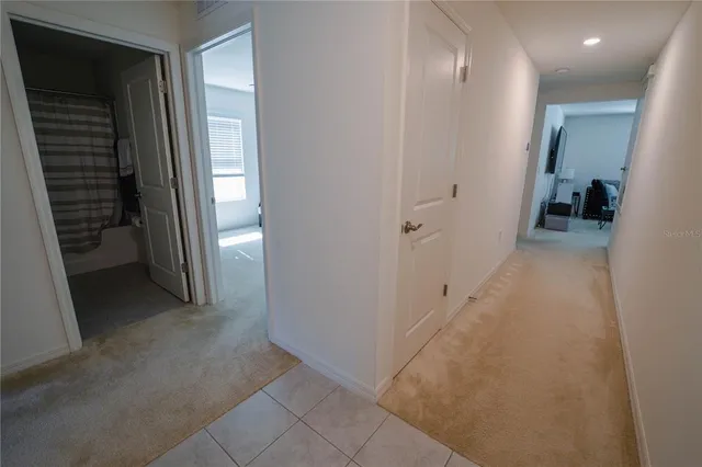 a front view of house with yard and trees in the background