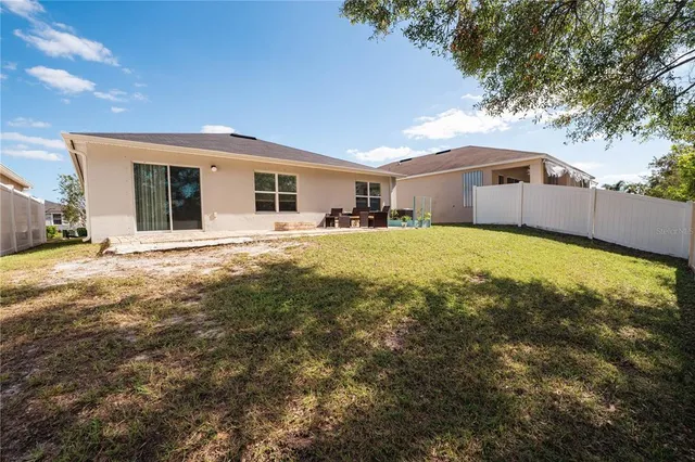 a view of a patio with couches chairs potted plants and water view