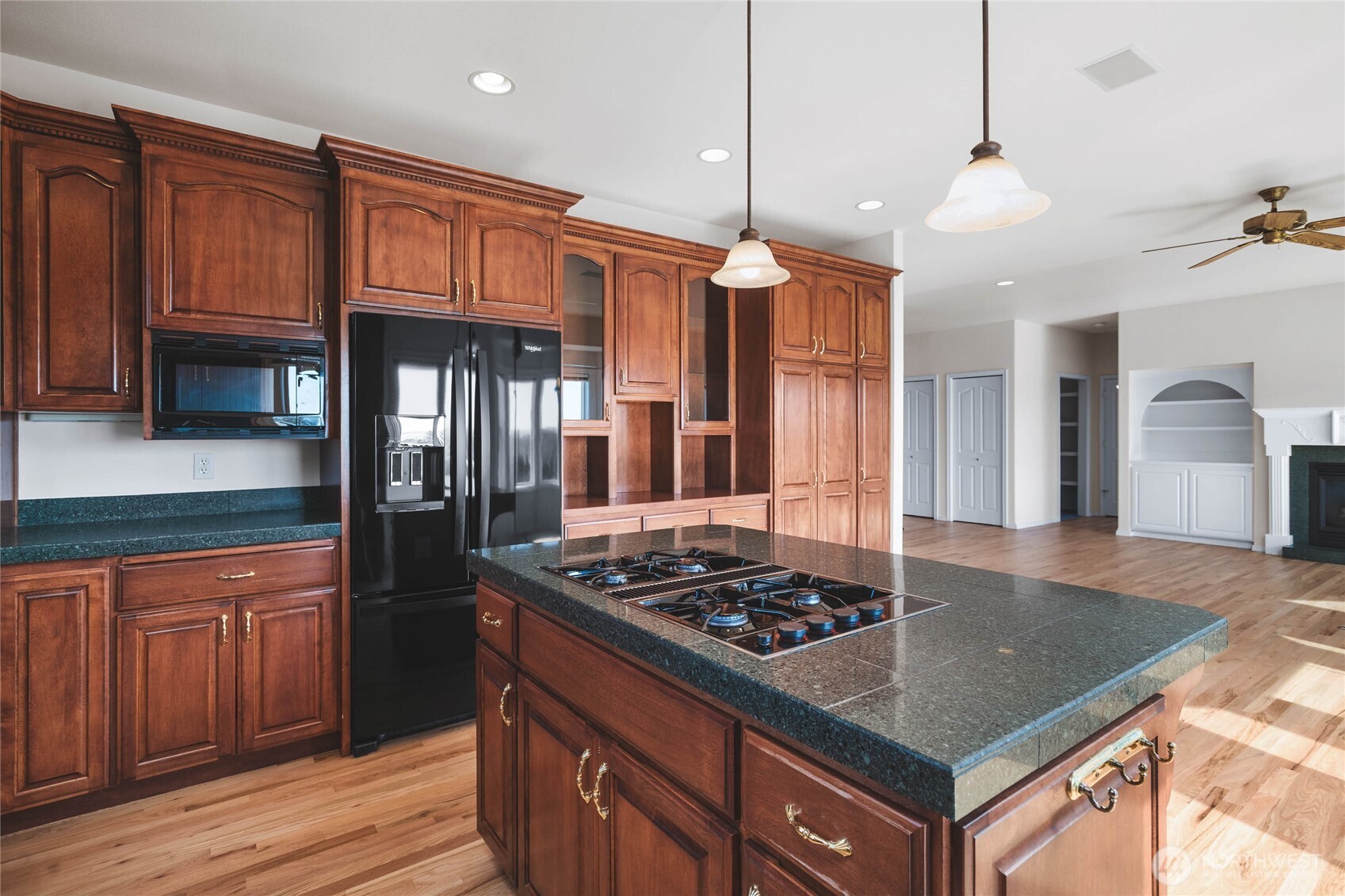 8661 Southridge Place Anacortes, WA 98221 - Photo 11 of 39 a kitchen with stainless steel appliances granite countertop a stove a sink and a refrigerator