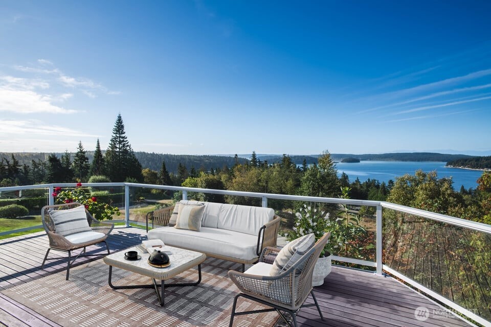 8661 Southridge Place Anacortes, WA 98221 - Photo 15 of 39 a balcony with wooden floor and outdoor seating