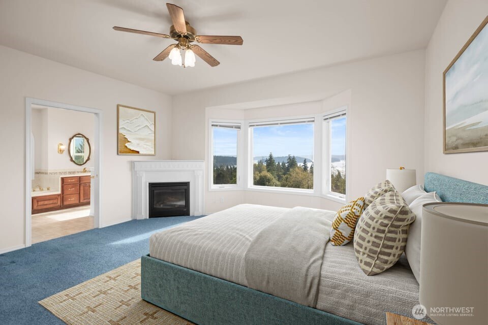 8661 Southridge Place Anacortes, WA 98221 - Photo 17 of 39 a bedroom with bed and a fireplace