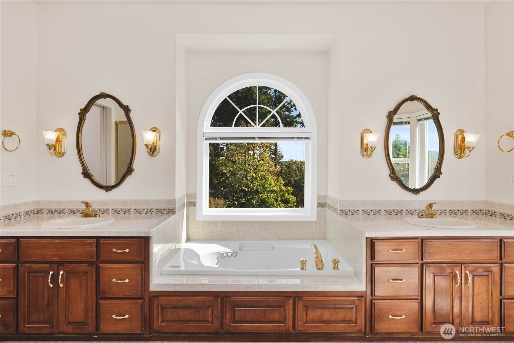8661 Southridge Place Anacortes, WA 98221 - Photo 18 of 39 a bathroom with a granite countertop a sink and a mirror