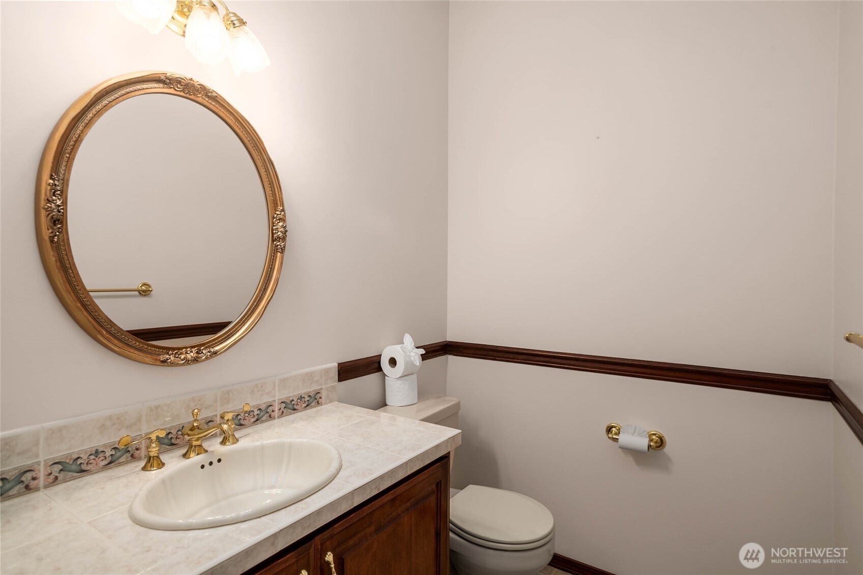 8661 Southridge Place Anacortes, WA 98221 - Photo 22 of 39 a bathroom with a sink mirror vanity and toilet