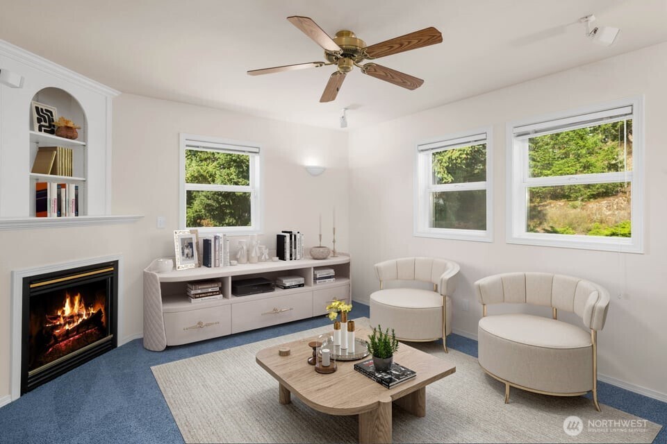8661 Southridge Place Anacortes, WA 98221 - Photo 23 of 39 a living room with furniture a fireplace and a window