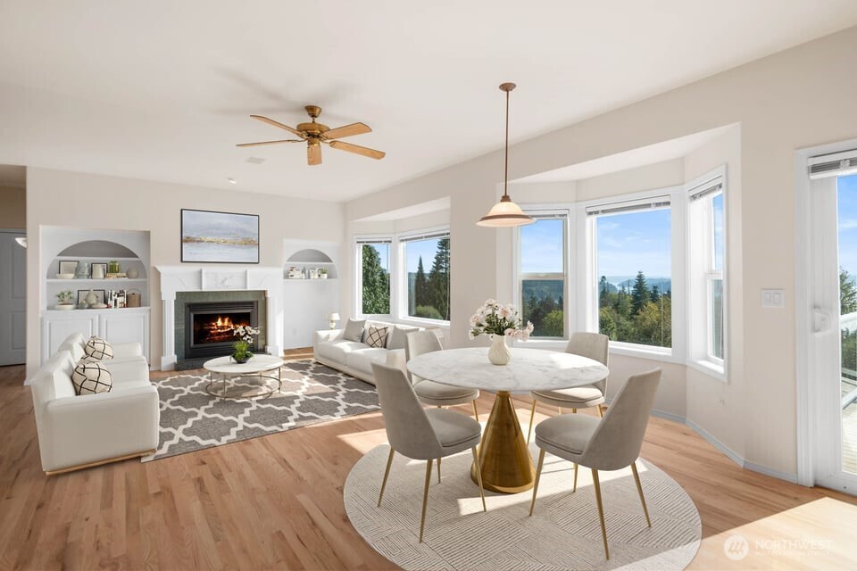 8661 Southridge Place Anacortes, WA 98221 - Photo 5 of 39 a view of a dining room with furniture window and wooden floor