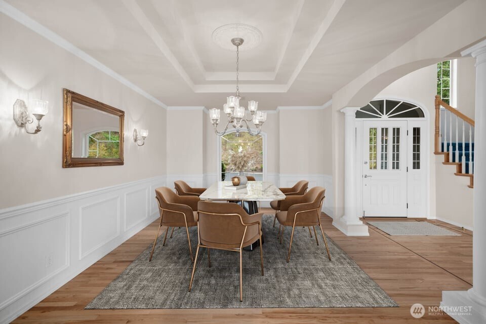 8661 Southridge Place Anacortes, WA 98221 - Photo 7 of 39 a dining room with furniture a rug and a chandelier