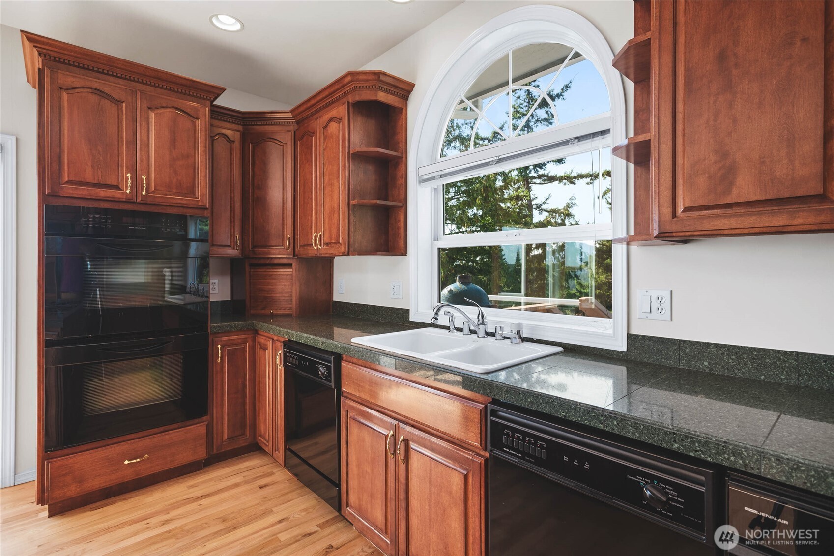 8661 Southridge Place Anacortes, WA 98221 - Photo 10 of 39 a kitchen with stainless steel appliances granite countertop a stove a sink and a microwave